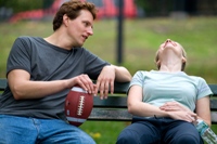 Guy and girl on park bench communicating verbally and nonverbally